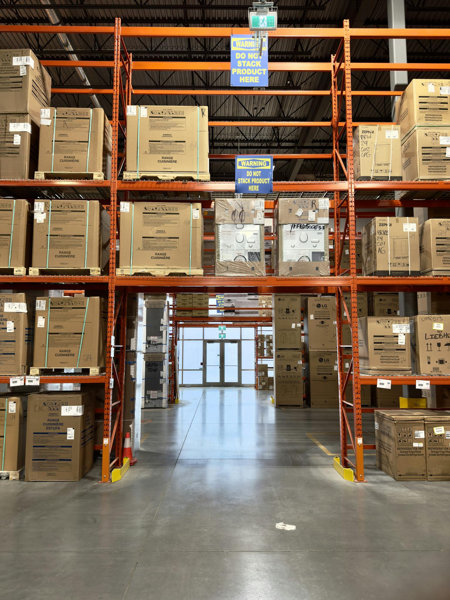 Large warehouse interior with racks filled with cardboard boxes, offering ample storage space.